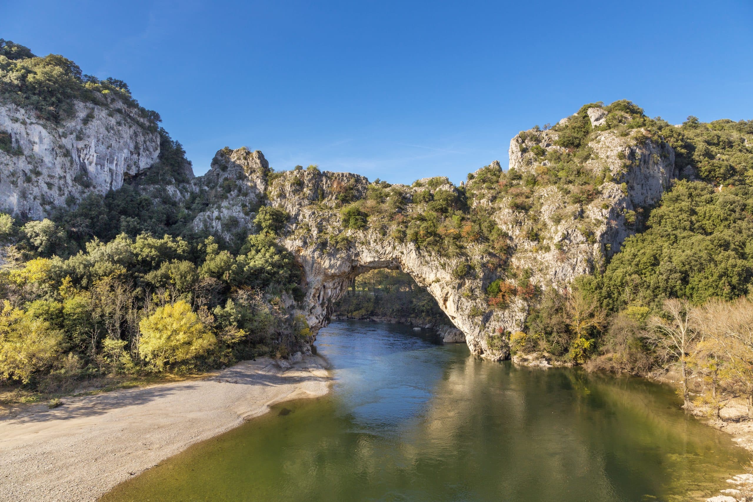 The natural landmark Pont dÂ´Arc at the Gorges de l'Ardeche in Vallon (France). A famous sightseeing and sports destination for kayaking and swimming.